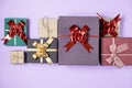 Holiday composition. Various handmade gift boxes on pastel violet background. Birthday concept.