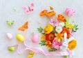 Holiday concept with bouquet of spring flowers, Easter eggs, bunny and butterfly on pastel vintage background. Easter composition Royalty Free Stock Photo
