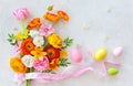 Holiday concept with bouquet of spring flowers Easter eggs and butterfly on pastel vintage background. Easter composition Royalty Free Stock Photo