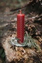 holiday concept candle on an old log in the forest Royalty Free Stock Photo