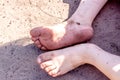 Holiday concept of dirty child feet on dirty soil Royalty Free Stock Photo