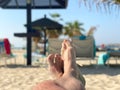Holiday concept. male feet close-up relaxing on beach, enjoying sun and splendid view.