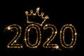 Holiday concept. Number 2020 with crown decor written sparkling sparklers isolated on black background. Overlay templatefor for Royalty Free Stock Photo