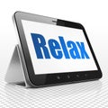 Holiday concept: Tablet Computer with Relax on display