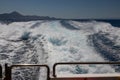 Holiday concept. Wake or sea spray behind fast gliding powerful boat or speedboat on the Aegean Sea. Close-up from deck. Vacation Royalty Free Stock Photo