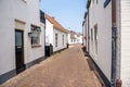 Holiday cottages along a stone alley in a seaside town on a clear summer day Royalty Free Stock Photo