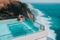 Holiday Couple relaxing in luxury with tropical water villa resort luxurious swimming pool with ocean view Bali , Indonesia Royalty Free Stock Photo