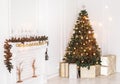 Holiday decorated room with Christmas tree and decoration, background with blurred, sparking, glowing light. Royalty Free Stock Photo