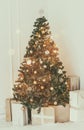 Holiday decorated room with Christmas tree and decoration, background with blurred, sparking, glowing light. Royalty Free Stock Photo