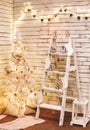 Holiday decorated room with Christmas tree and decoration, background with blurred, sparking, glowing light Royalty Free Stock Photo
