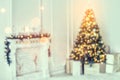 Holiday decorated room with Christmas tree and decoration, background with blurred, sparking, glowing light. Royalty Free Stock Photo