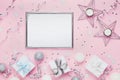 Holiday decoration, frame and gift boxes on stylish pink table top view. Fashion christmas background. Flat lay. Party mockup. Royalty Free Stock Photo