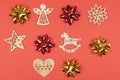 Holiday decorations. Composition made of red and gold bows, wooden Christmas tree toys on red background. top view, closeup Royalty Free Stock Photo