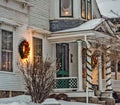 Holiday decorations light up front of New England Farm house