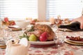 Holiday dinner table with roasted turkey, man pouring red wine in foreground Royalty Free Stock Photo