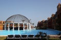 holiday in Egypt with a luxury hotel swimming pool with blue water and a bar with sculptures