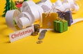 Holiday expenses concept. Long twisted christmas expenses list, presents, gifts, money coins and christmas text Royalty Free Stock Photo