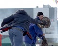 Holiday farewell to winter. Fight on a pillow standing on a log.