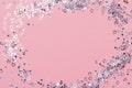 Holiday Festive background. gold and silver star confetti glitter scattered on pink background. Royalty Free Stock Photo