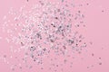 Holiday Festive background. gold and silver star confetti glitter scattered on pink background. Royalty Free Stock Photo