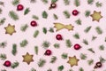 Holiday Festive Flat Lay Background with Small Green Branches Fir Tree Red Christmas Balls and Gingerbread Cookies on Pink Royalty Free Stock Photo