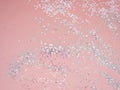 Holiday festive glitter background with pattern from scattered golden silver stars on light pink backdrop. New Years or Christmas Royalty Free Stock Photo