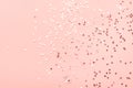 Holiday festive glitter background with pattern from scattered sparkling golden silver stars on pink. New Years Christmas Royalty Free Stock Photo