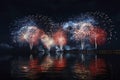 Holiday fireworks above water with reflection on the black sky background.