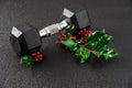 Holiday fitness, single dumbbell on a gym floor with a fresh sprig of festive Christmas holly