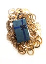 Holiday flat lay, gift and gold chain. Color photo on a white background