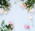 Holiday flowers background. Beautiful bouquets of pale pink roses and ranunculus flowers and macaroons cakes