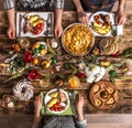 Holiday friends or family at the holiday table with rabbit meat, vegetables, pies, eggs, top view