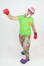 The clown plays boxing. Isolated on white