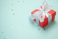 Holiday gift box with bow. Birthday surprise, Valentines day present with red satin tape close up. Copy space Royalty Free Stock Photo