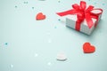 Holiday gift box with bow. Birthday surprise, Valentines day present with red satin tape close up. Copy space Royalty Free Stock Photo