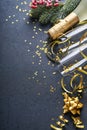 Holiday gift box or present with ribbon, golden confetti and gold baubles on black background. Magic christmas greeting card. Chri Royalty Free Stock Photo