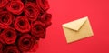 Love letter and flower delivery service on Valentines Day, luxury bouquet of red roses and card envelopes on red background Royalty Free Stock Photo