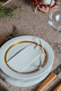 Holiday Gold place setting,  Christmas table with ornaments and natural pine branch on the livingroom home Royalty Free Stock Photo