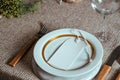 Holiday Gold place setting,  Christmas table with ornaments and natural pine branch on the livingroom home Royalty Free Stock Photo