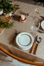 Holiday Gold place setting,  Christmas table with ornaments and natural pine branch on the livingroom home Royalty Free Stock Photo