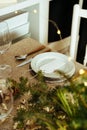 Holiday Gold place setting,  Christmas table with ornaments and natural pine branch on the livingroom home Royalty Free Stock Photo