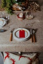 Holiday Gold place setting,  Christmas table with ornaments and natural pine branch on the livingroom home Royalty Free Stock Photo