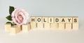 Holiday at home concept. Hand turns a cube Royalty Free Stock Photo