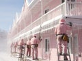 Holiday Home Makeover: Winter Workers in Santa Caps Transforming a Pastel Pink House