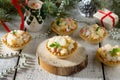 Holiday hors d`oeuvre: tartlets with crab sticks, cheese and pineapple on a celebratory Christmas background Royalty Free Stock Photo