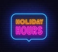 Holiday Hours neon sign in the speech bubble on brick wall background.