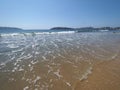 Holiday landscape of sandy beach at bay of ACAPULCO city in Mexico with white waves of Pacific Ocean Royalty Free Stock Photo