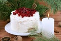 Holiday layered cake with cream and cranberry decoration