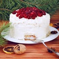 Holiday layered cake with cream and cranberry decoration