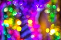 Holiday lighting and decoration concept - christmas garland with bokeh lights on dark blue background, Royalty Free Stock Photo